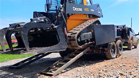 how to load a skid steer on a dump trailer|skid steer trailer moving attachment.